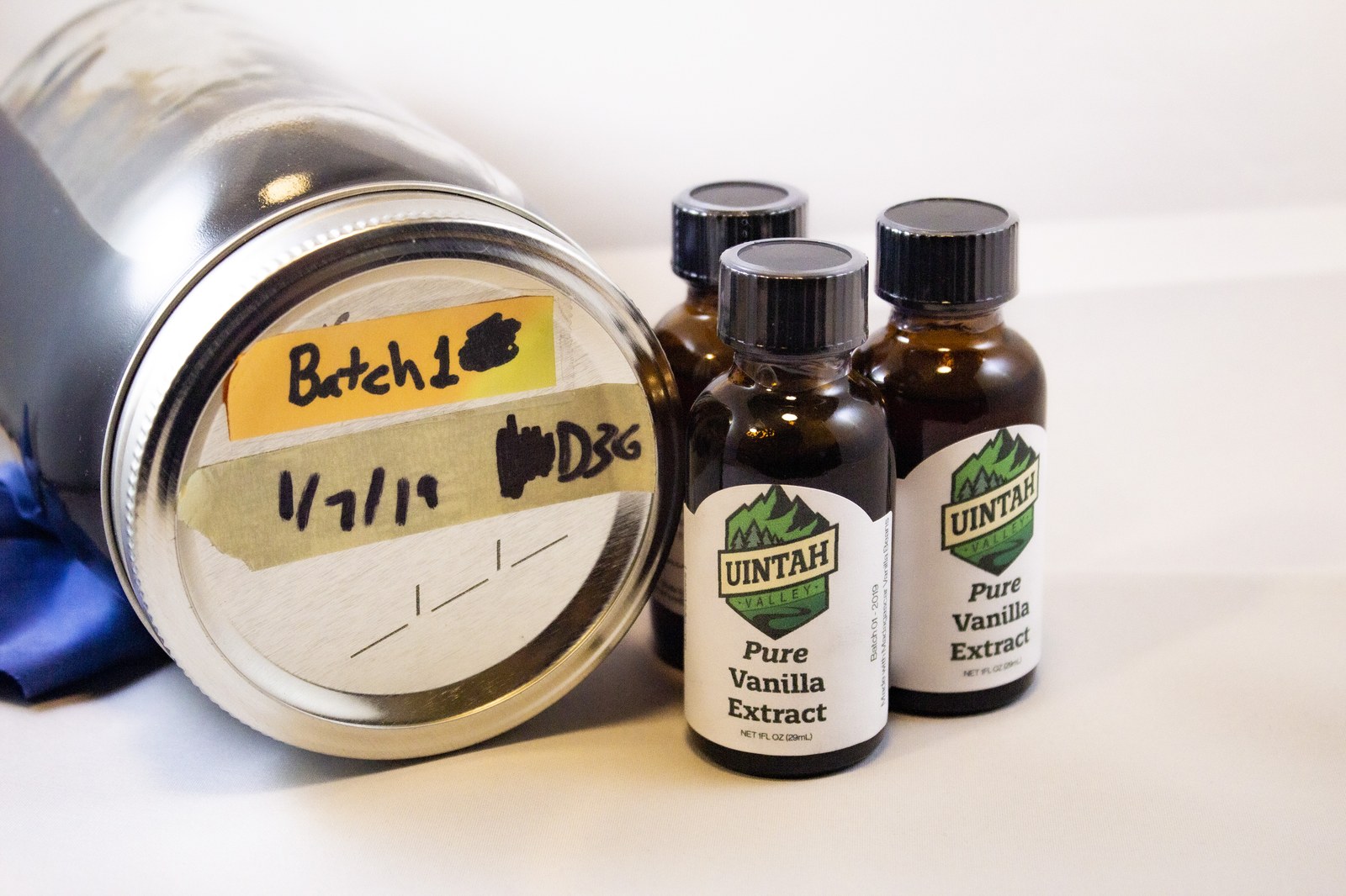 Jar and three labeled bottles of Uintah Valley Pure Vanilla Extract